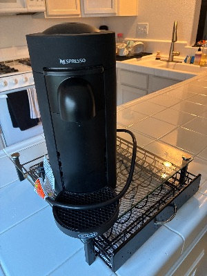 Nespresso VertuoPlus (De'Longhi, matte black) + glass capsule drawer stand + refill kit — $100 1